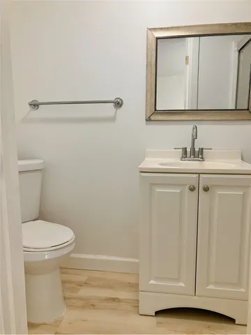 a bathroom with a sink a toilet and mirror