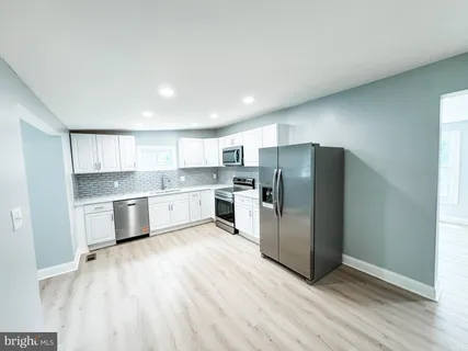 a view of a livingroom with a furniture wooden floor and a ceiling fan