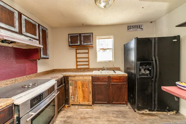 a view of an empty room with a fireplace