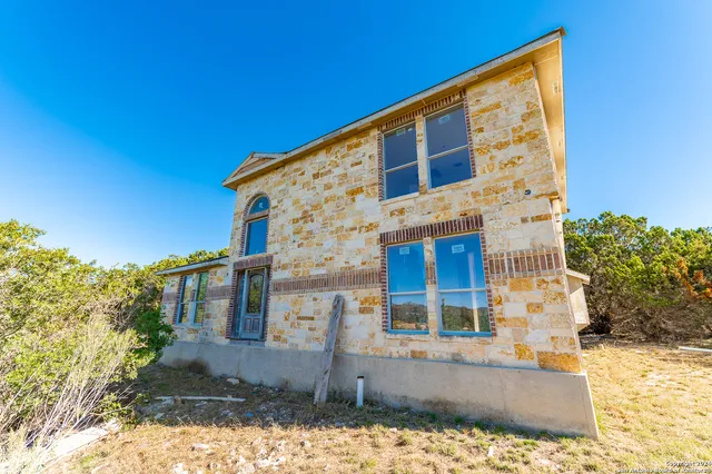 an empty room with a window and a bathroom