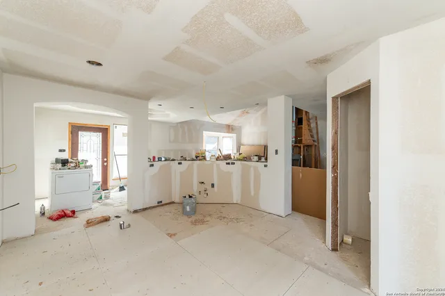 a view of a house with a yard and lake view
