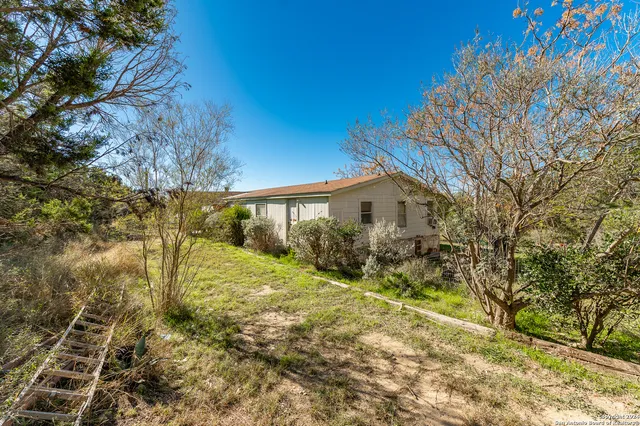 a bathroom with a sink a toilet a mirror and bathtub