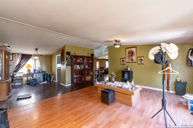 a view of a room with wooden floor and furniture