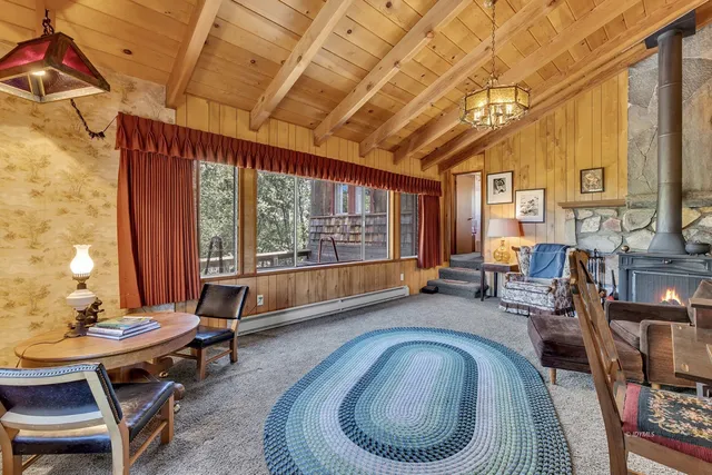 a living room with patio furniture and a chandelier