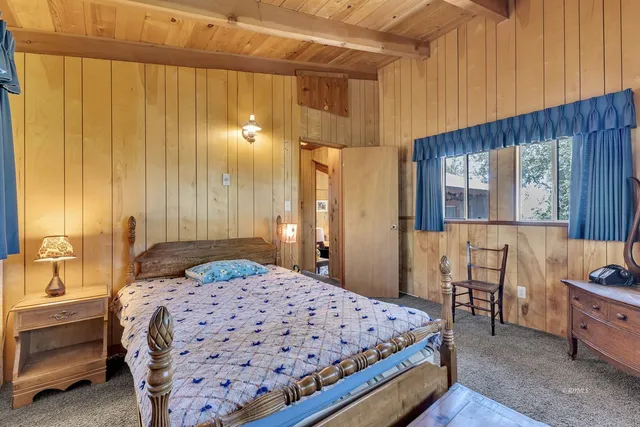 a bedroom with a bed next to a window with outer view