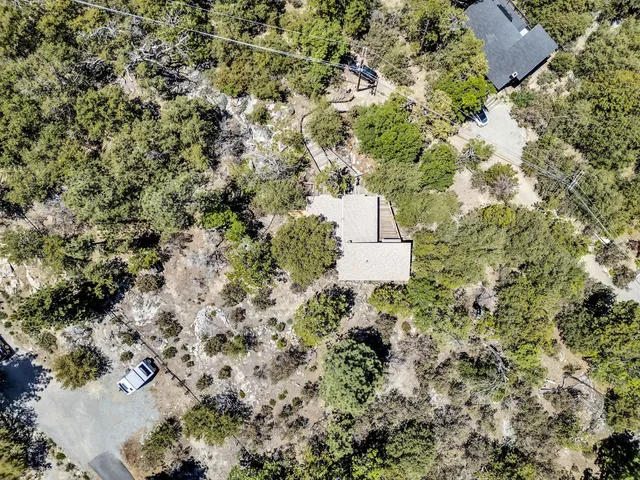 an aerial view of a house with a yard