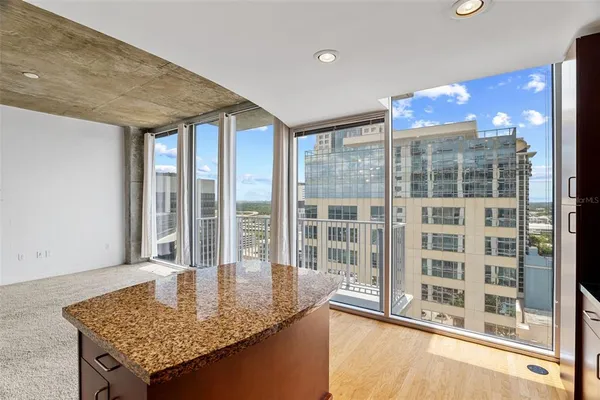 a view of a kitchen with granite countertop and a large window