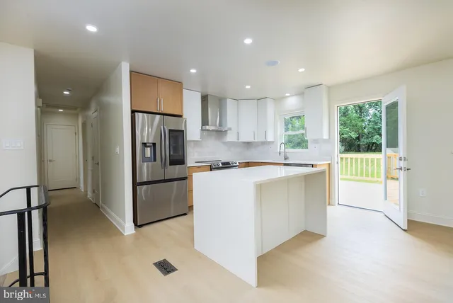 an empty room with a window and a ceiling fan