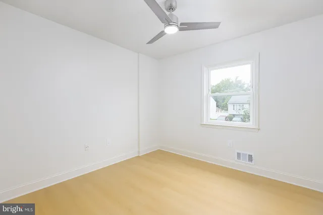 a bathroom with a granite countertop toilet a sink and mirror