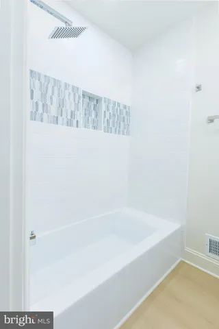 a view of a house with a wooden deck and a yard