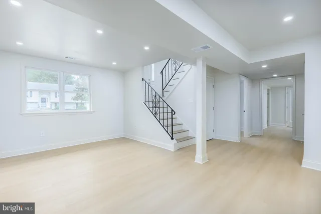 an aerial view of residential houses with outdoor space and trees