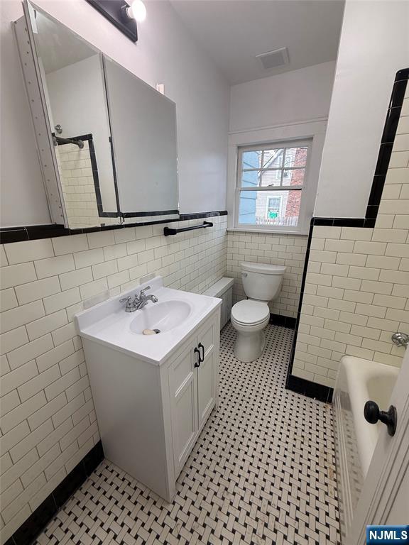131 West Ramapo Avenue Mahwah, NJ 07430 - Photo 20 of 27 a bathroom with a sink a toilet a mirror and window