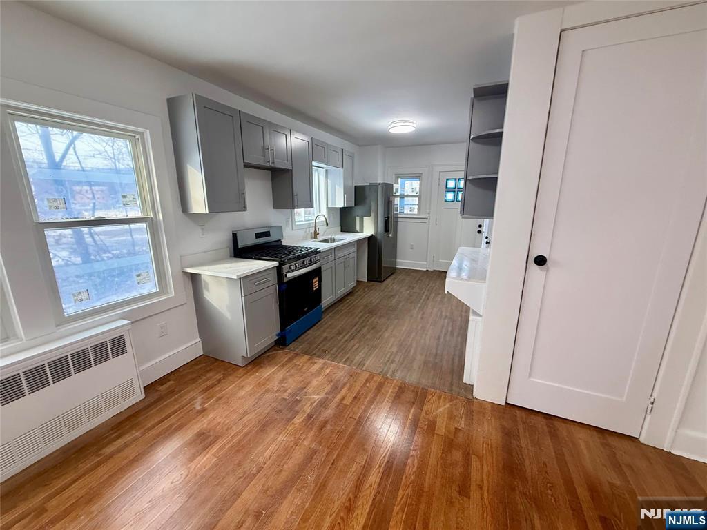 131 West Ramapo Avenue Mahwah, NJ 07430 - Photo 2 of 27 a kitchen with stainless steel appliances granite countertop a refrigerator a sink dishwasher a stove and white countertops with wooden floor