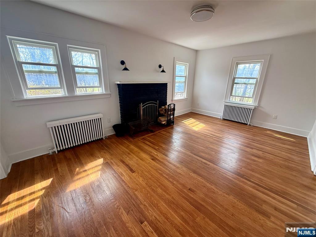 131 West Ramapo Avenue Mahwah, NJ 07430 - Photo 5 of 27 a view of an empty room with wooden floor fireplace and a window