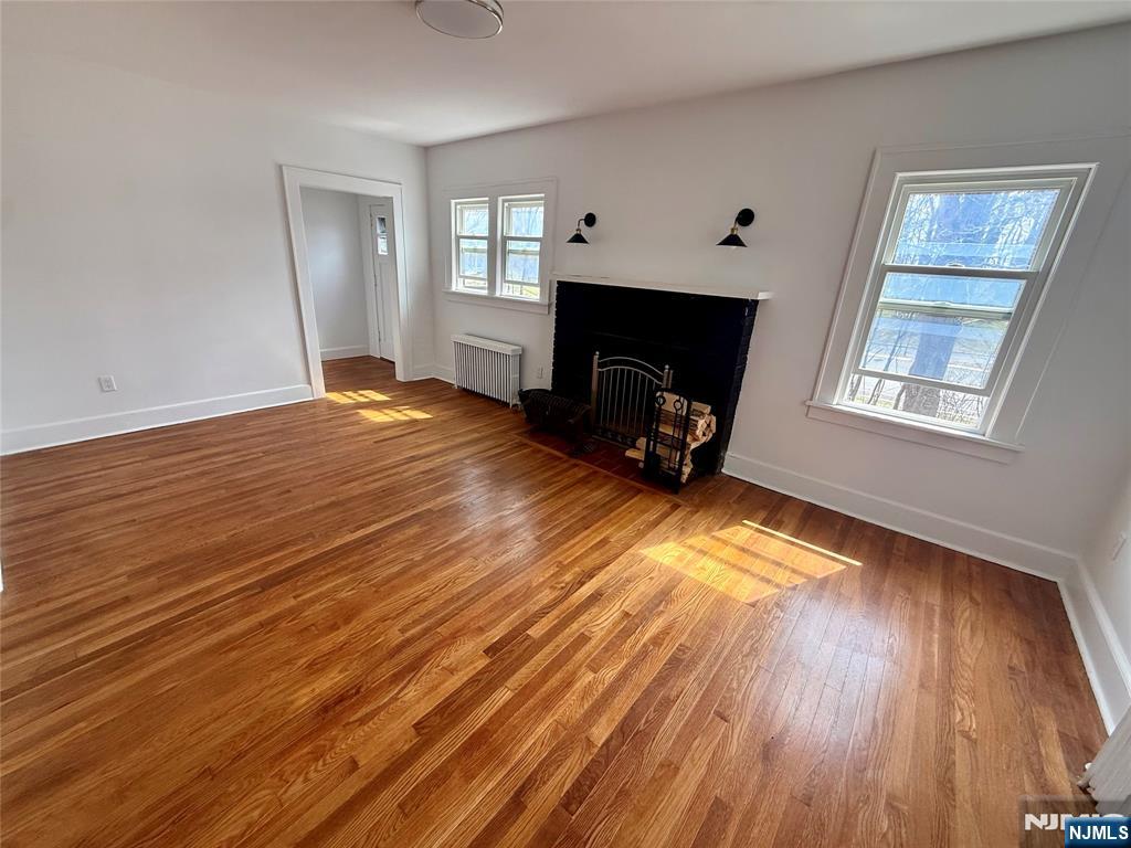 131 West Ramapo Avenue Mahwah, NJ 07430 - Photo 6 of 27 a view of a livingroom with wooden floor and a fireplace