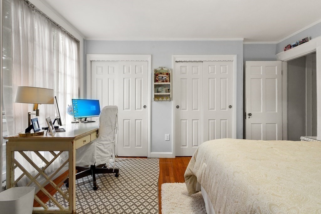 2 Charlotte Road Marblehead, MA 01945 - Photo 21 of 29 a bedroom with a bed and a table in it