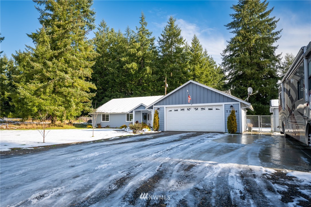 7514 191st Avenue Southwest Rochester, WA 98579 - Photo 2 of 39 a view of a house with a yard and large trees