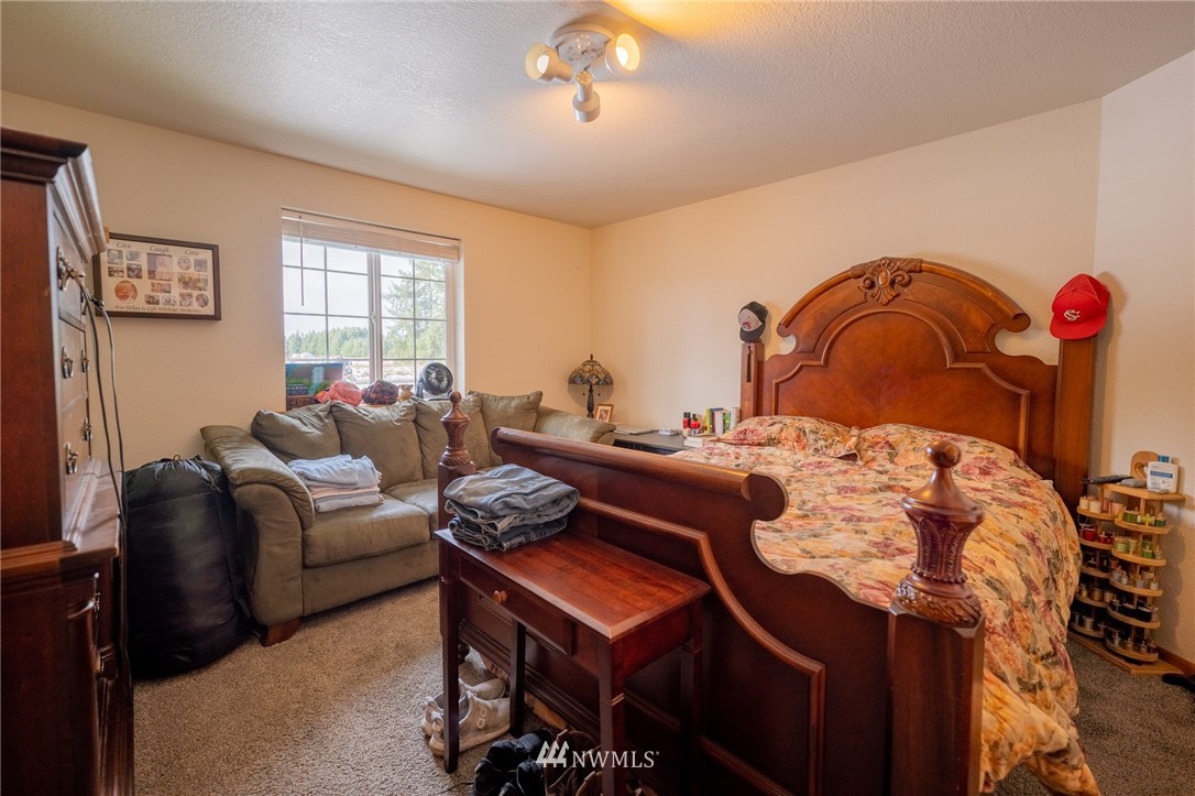 7514 191st Avenue Southwest Rochester, WA 98579 - Photo 13 of 39 a living room with furniture a rug and a window