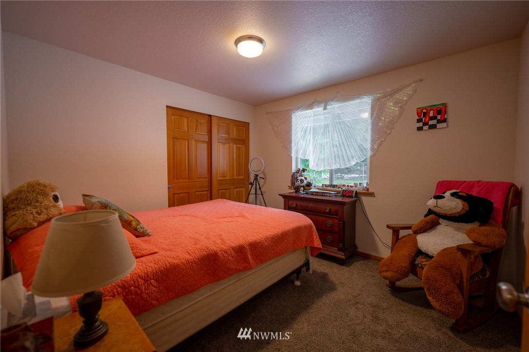 7514 191st Avenue Southwest Rochester, WA 98579 - Photo 14 of 39 a bedroom with a bed and a window