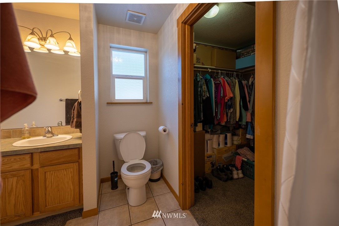 7514 191st Avenue Southwest Rochester, WA 98579 - Photo 22 of 39 a bathroom with a toilet sink and mirror
