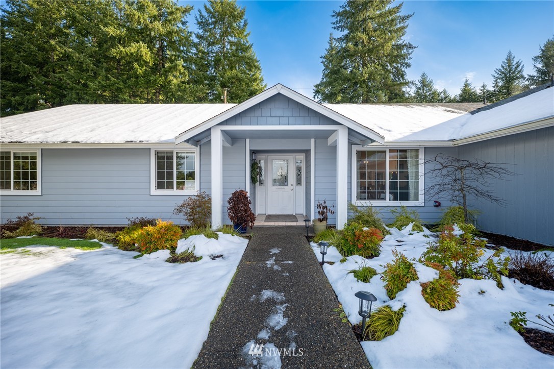 7514 191st Avenue Southwest Rochester, WA 98579 - Photo 4 of 39 a front view of a house with yard and flowers
