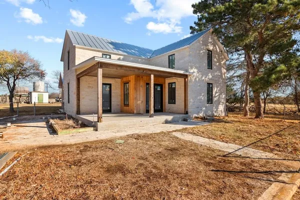 a view of a house with snow on the road