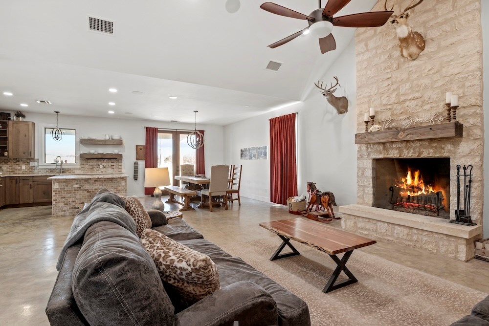 1410 Grapetown Road Fredericksburg, TX 78624 - Photo 17 of 60 a living room with furniture and a fireplace