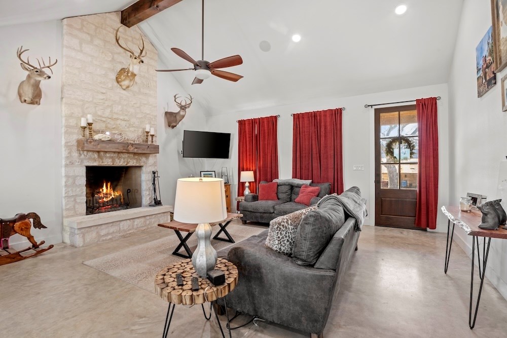 1410 Grapetown Road Fredericksburg, TX 78624 - Photo 20 of 60 a living room with furniture and a fireplace
