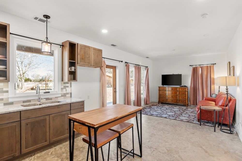 1410 Grapetown Road Fredericksburg, TX 78624 - Photo 39 of 60 a living room with furniture and a flat screen tv