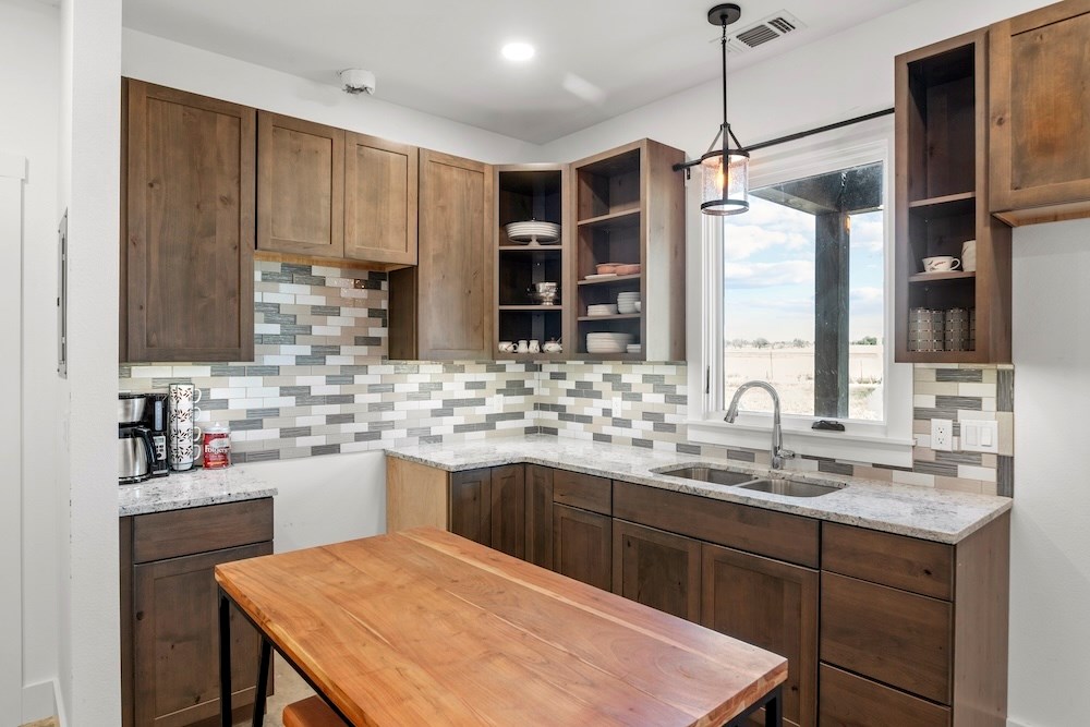 1410 Grapetown Road Fredericksburg, TX 78624 - Photo 40 of 60 a kitchen with a sink stove and refrigerator