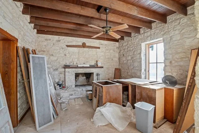 a living room with furniture a fireplace and a table