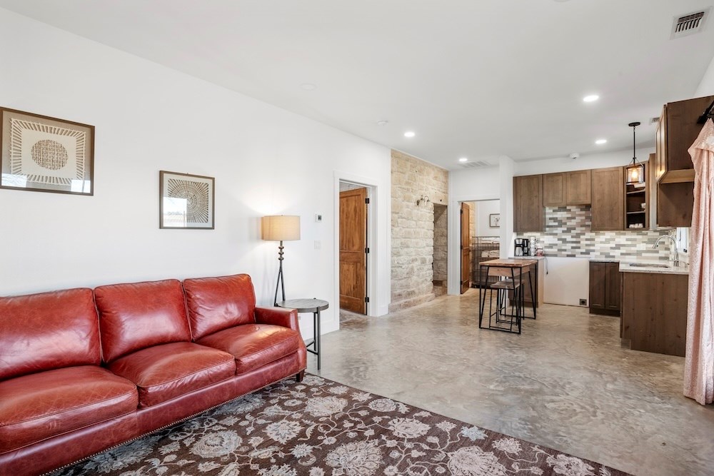 1410 Grapetown Road Fredericksburg, TX 78624 - Photo 42 of 60 a living room with stainless steel appliances kitchen island granite countertop furniture and a couch