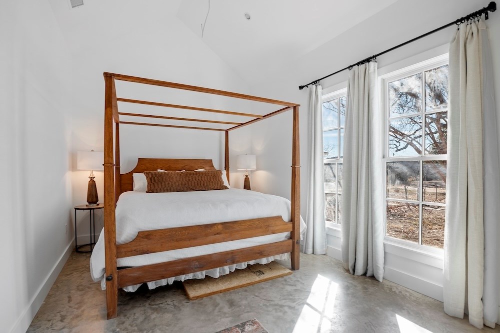 1410 Grapetown Road Fredericksburg, TX 78624 - Photo 43 of 60 a bedroom with a bed and window