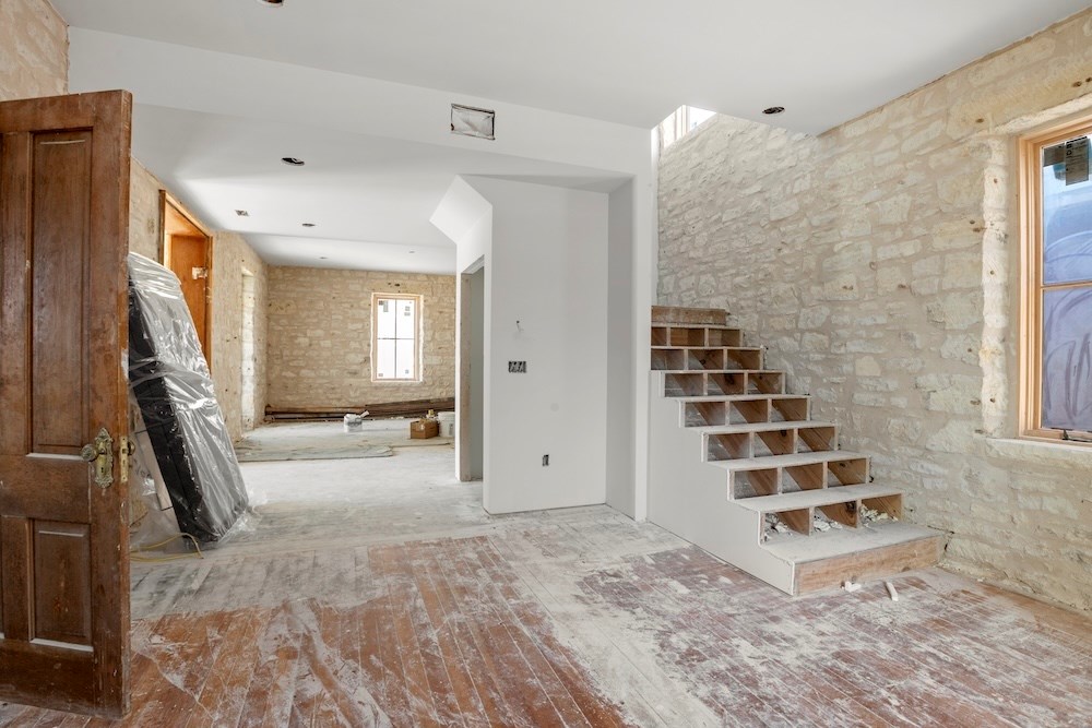 1410 Grapetown Road Fredericksburg, TX 78624 - Photo 10 of 60 a view of a bedroom with wooden floor and windows