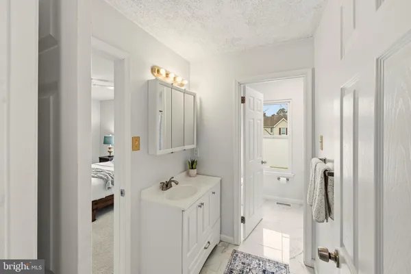 a bathroom with a double vanity sink mirror and shower