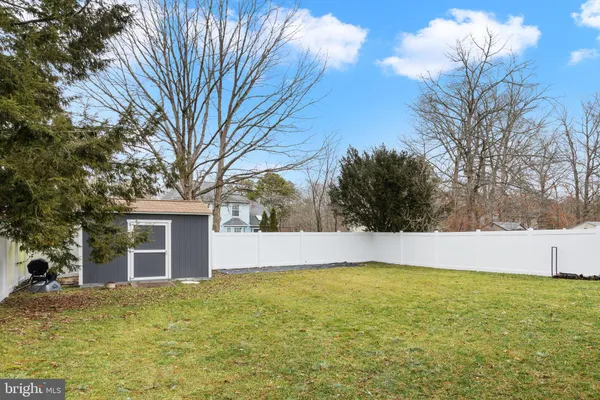 a view of a backyard with large trees
