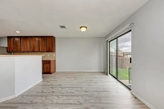 a view of a kitchen with a sink and cabinets