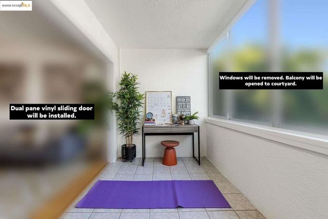 a large living room with stainless steel appliances furniture and a kitchen