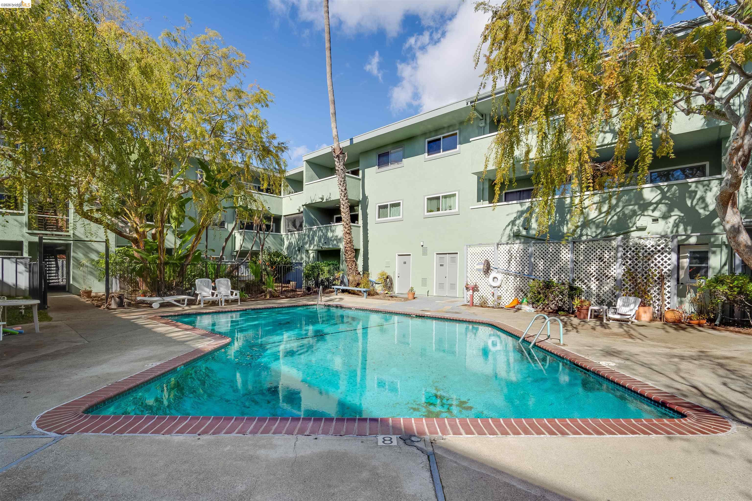 325 Kitty Hawk Road, Unit 207 Alameda, CA 94501 - Photo 20 of 43 a view of a swimming pool with a patio