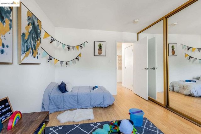 a bedroom with furniture and a painting on the wall