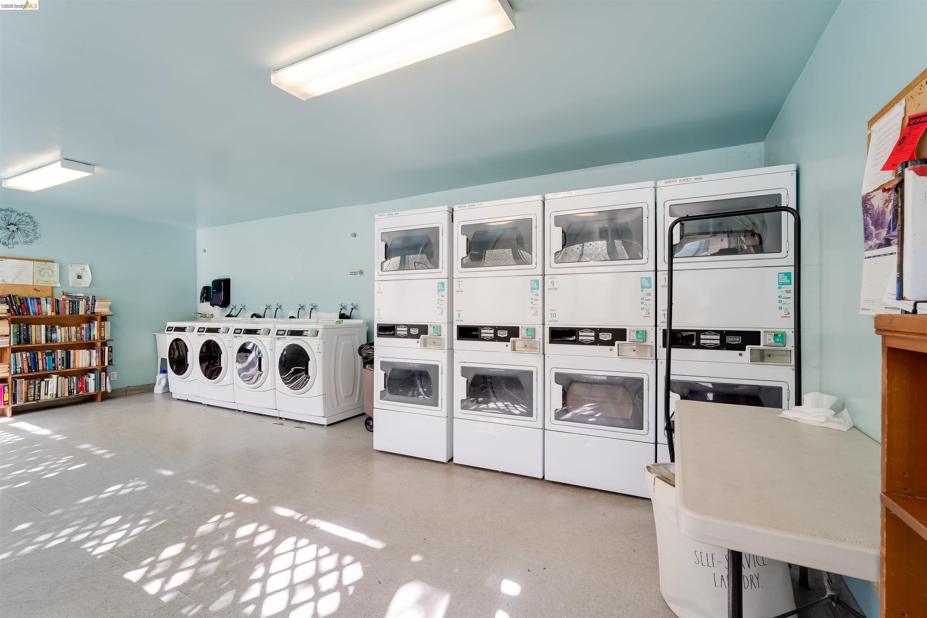 325 Kitty Hawk Road, Unit 207 Alameda, CA 94501 - Photo 23 of 43 a white kitchen with stainless steel appliances a stove a sink and a microwave