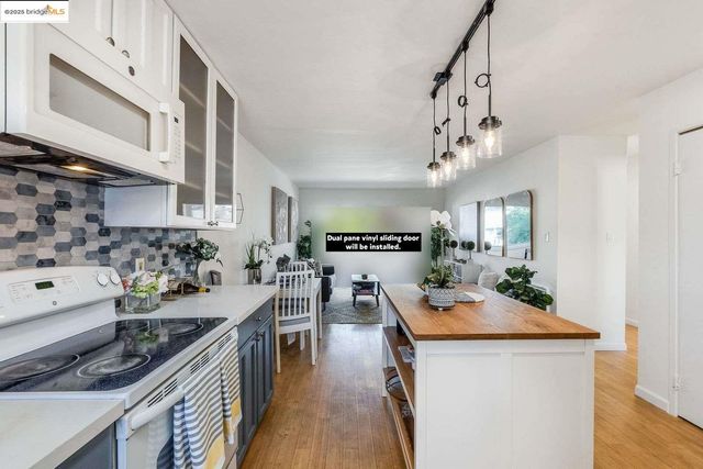 a kitchen with stainless steel appliances granite countertop a stove and cabinets