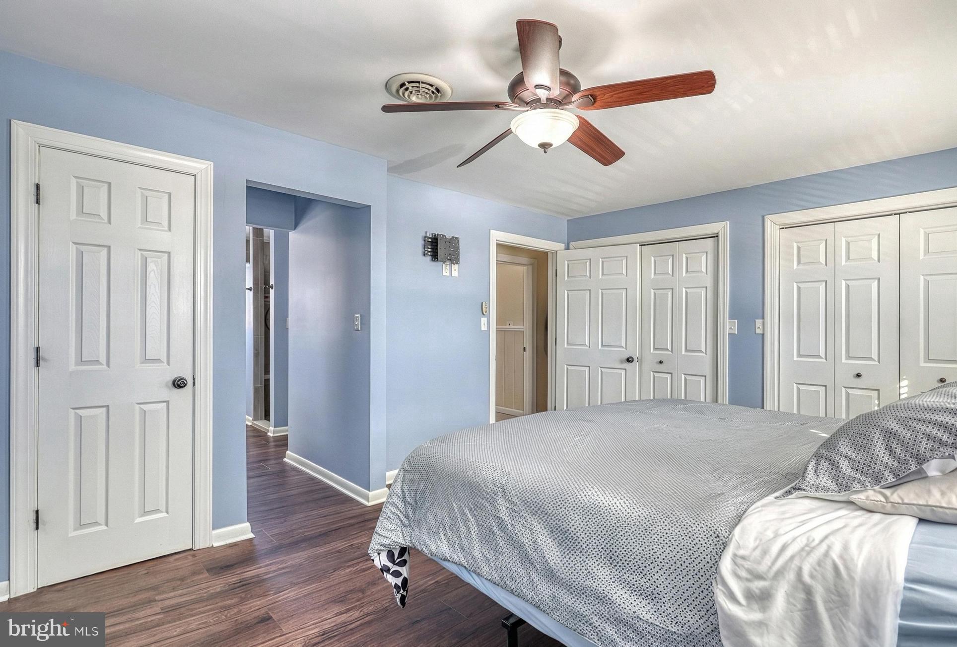 809 Flintlock Ridge Road Mechanicsburg, PA 17055 - Photo 21 of 46 a bedroom with a large bed chandelier and a window