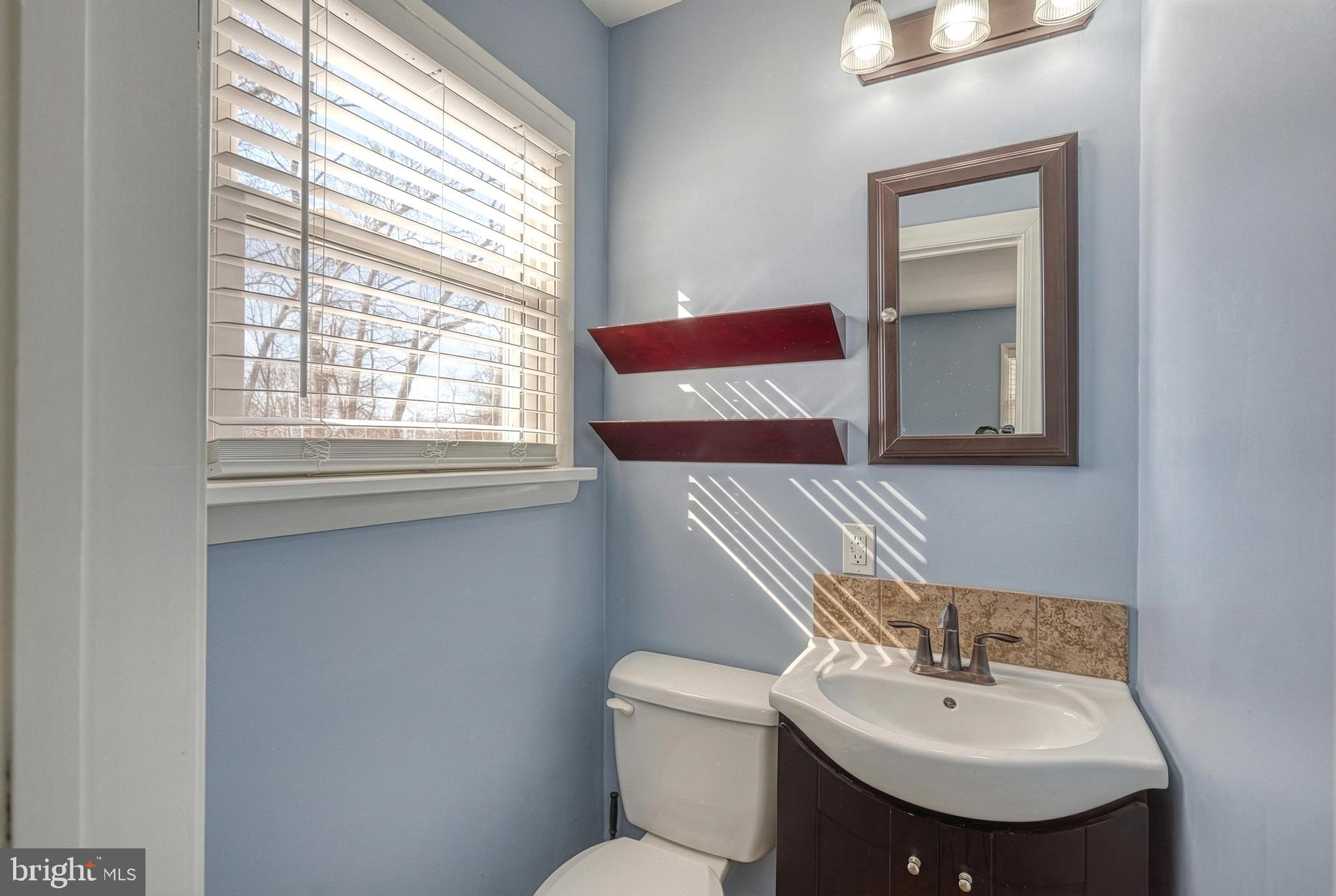 809 Flintlock Ridge Road Mechanicsburg, PA 17055 - Photo 25 of 46 a bathroom with a sink toilet and mirror