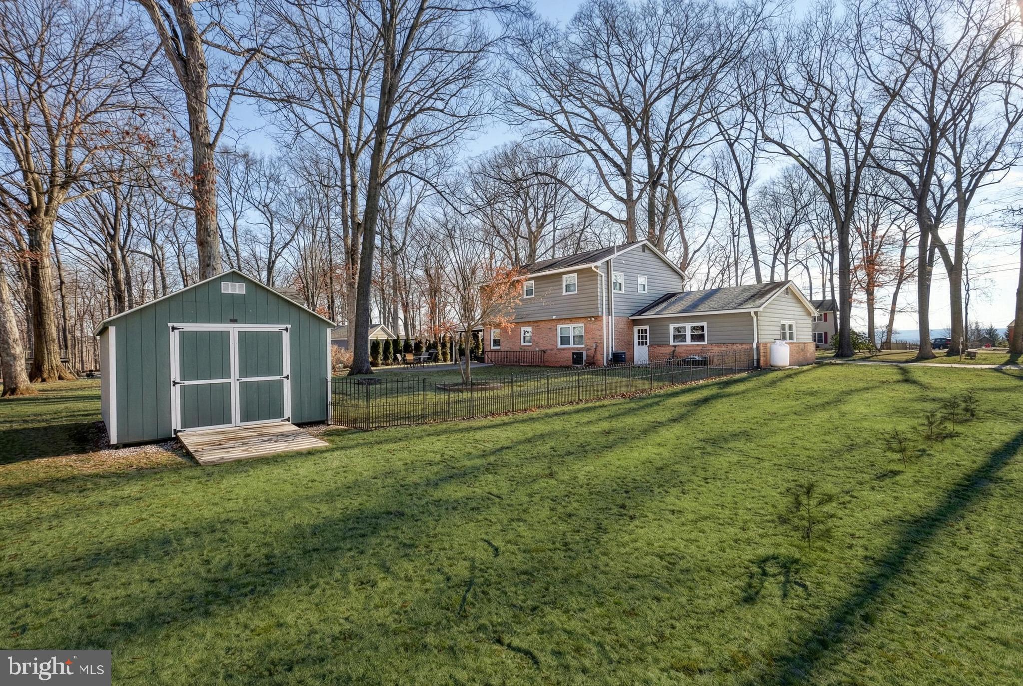 809 Flintlock Ridge Road Mechanicsburg, PA 17055 - Photo 42 of 46 a front view of a house with a yard and trees