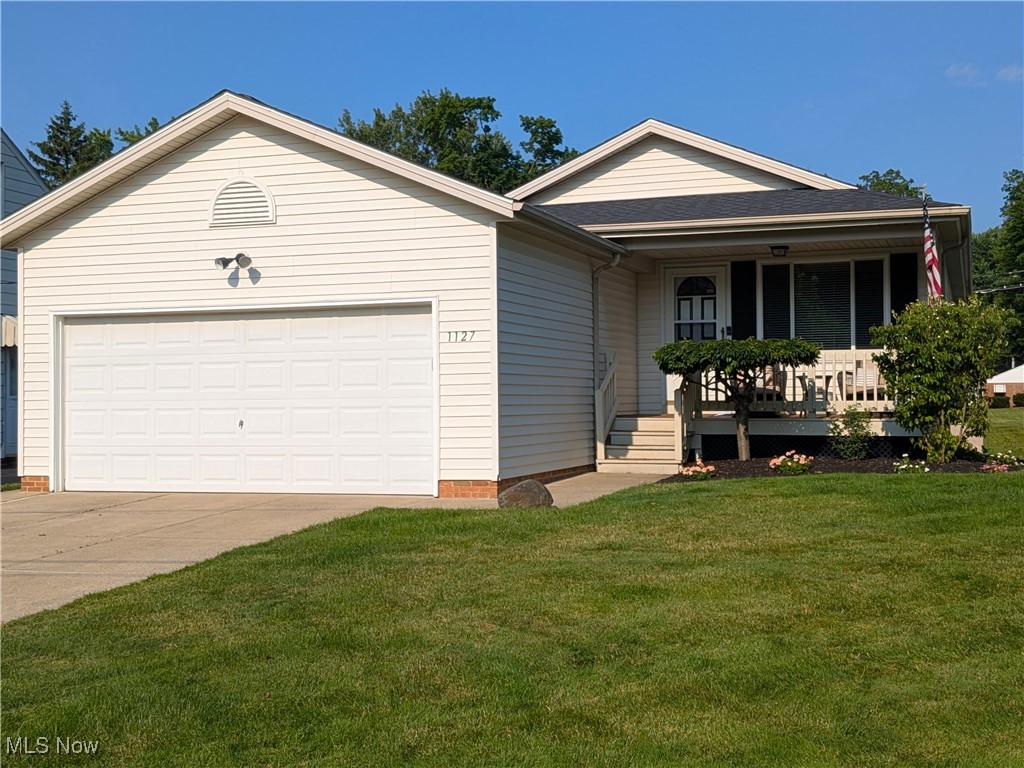 1127 Mayfield Ridge Road Cleveland, OH 44124 - Photo 1 of 47 Ranch-style home featuring driveway, covered porch, a front lawn, and a garage