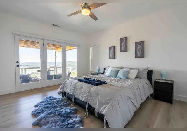 a bedroom with a large bed and a large window