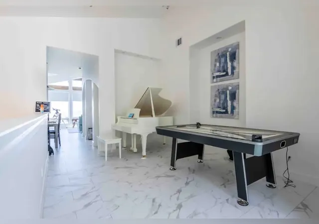 a living room with furniture and a floor to ceiling window