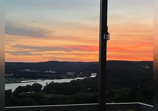 a view of balcony with wooden floor and fence