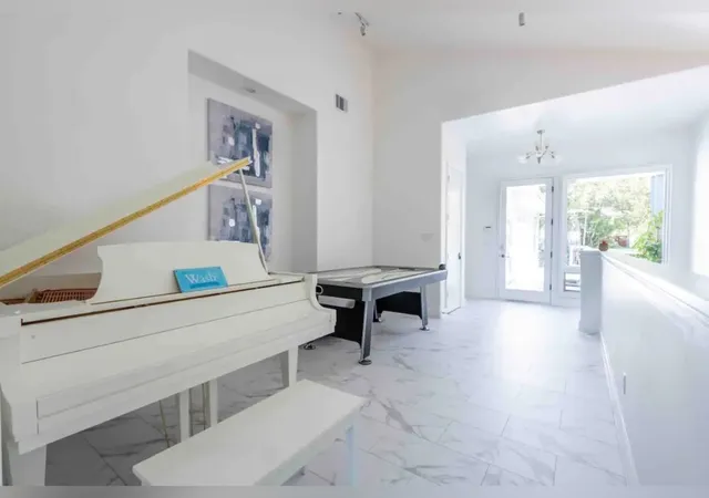 a hallway with table and white walls